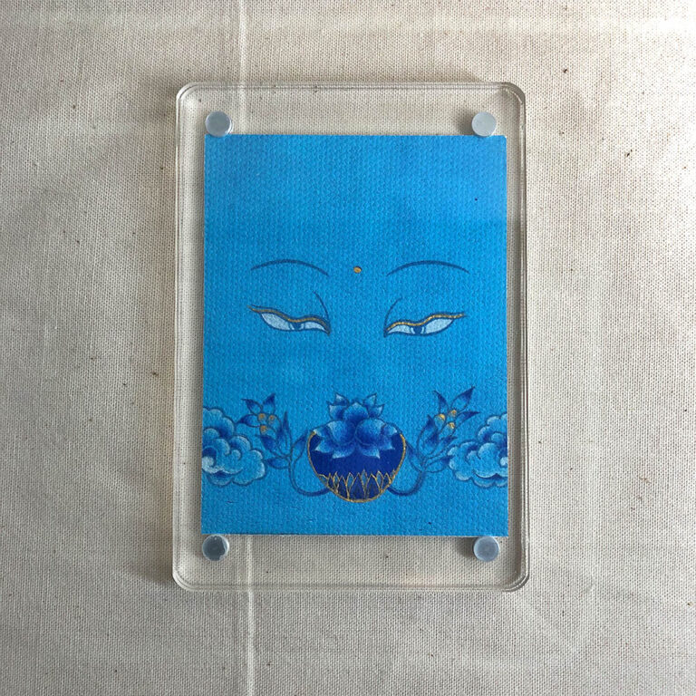 Frontal view of Medicine Buddha Eyes acrylic block for blue color meditation.