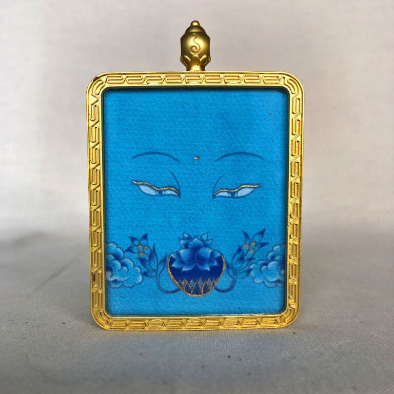 Frontal view of Medicine Buddha Eyes pendant for Throat Chakra color meditation.