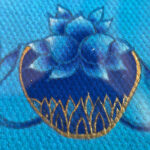 Close-up of original hand-painted gold linework and healing bowl on blue canvas texture.