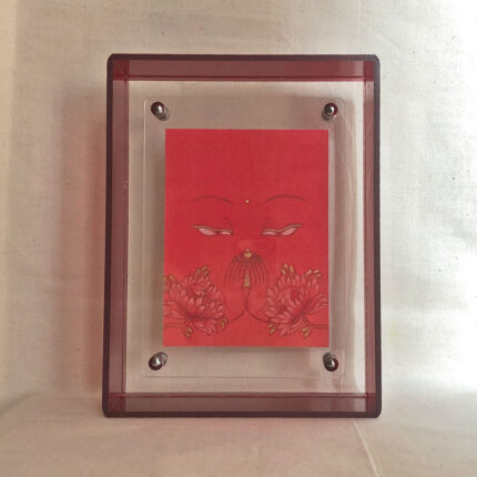 Front view of orange Avalokiteshvara Buddha Eyes print in a red floating translucent acrylic frame.