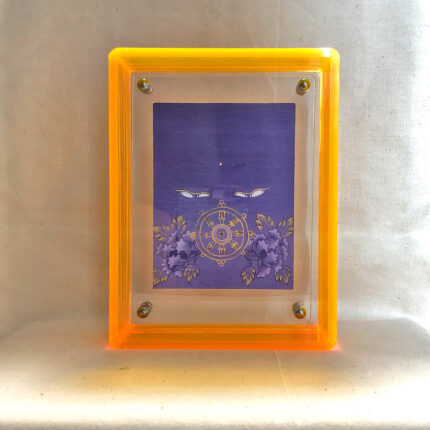 Front view of purple Vairochana Buddha Eyes print in a yellow floating translucent acrylic frame.