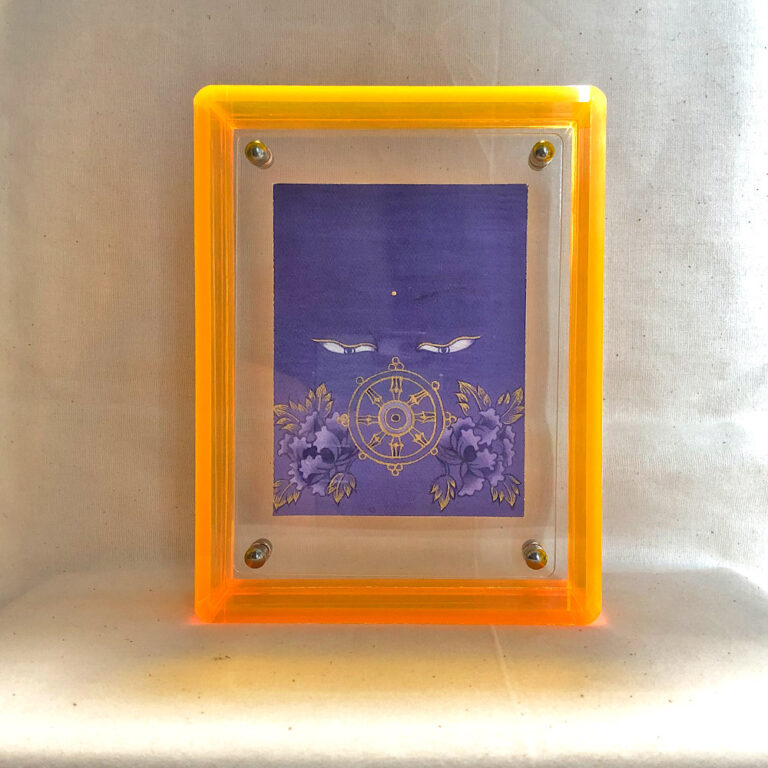 Front view of purple Vairochana Buddha Eyes print in a yellow floating translucent acrylic frame.