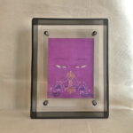 Front view of purple Vajrasattva Buddha Eyes print in a grey floating translucent acrylic frame.