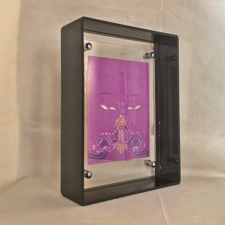 Side perspective of purple Vajrasattva Buddha Eyes art inside a grey translucent acrylic frame.