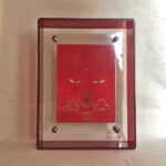 Front view of red Amitayus Buddha Eyes print in a red floating translucent acrylic frame.