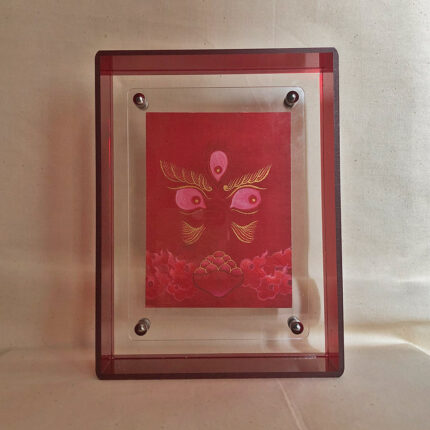 Front view of red Jambhala Buddha Eyes print in a red floating translucent acrylic frame.
