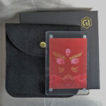 Red Jambhala portable acrylic block displayed with protective pouch and packaging box.