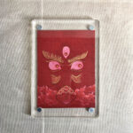 Frontal view of Red Jambhala Buddha Eyes acrylic block for red color meditation.
