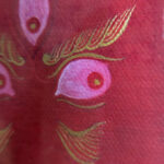 Close-up of original hand-painted gold linework and wisdom eyes on red canvas texture.