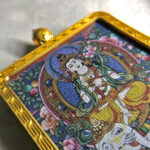 Close-up of Samantabhadra Bodhisattva pendant in gold Gau box for zodiac guardian meditation
