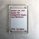 Backside of clear acrylic frame displaying artist signature card and magnetic corner screws.