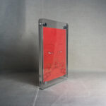 Side-angle view of freestanding clear acrylic block displaying Shakyamuni Buddha line art.