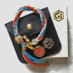Shakyamuni Buddha Eyes orange bracelet presented with velvet pouch and Golden Ink Arts box.