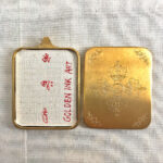 Openable view of the brass Gau box displaying backside art and sacred inner compartment.