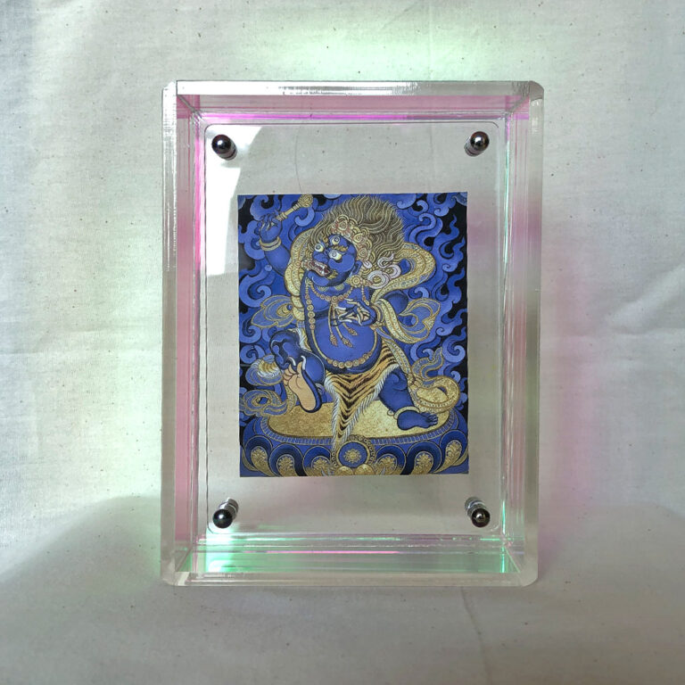 Front view of blue Vajrapani Thangka print in an iridescent rainbow floating acrylic frame.