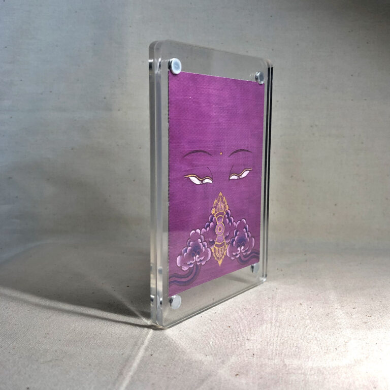 Side-angle view of freestanding clear acrylic block displaying Vajrasattva line art.