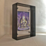 Side perspective of purple Vajrasattva Thangka print inside a black acrylic display frame.