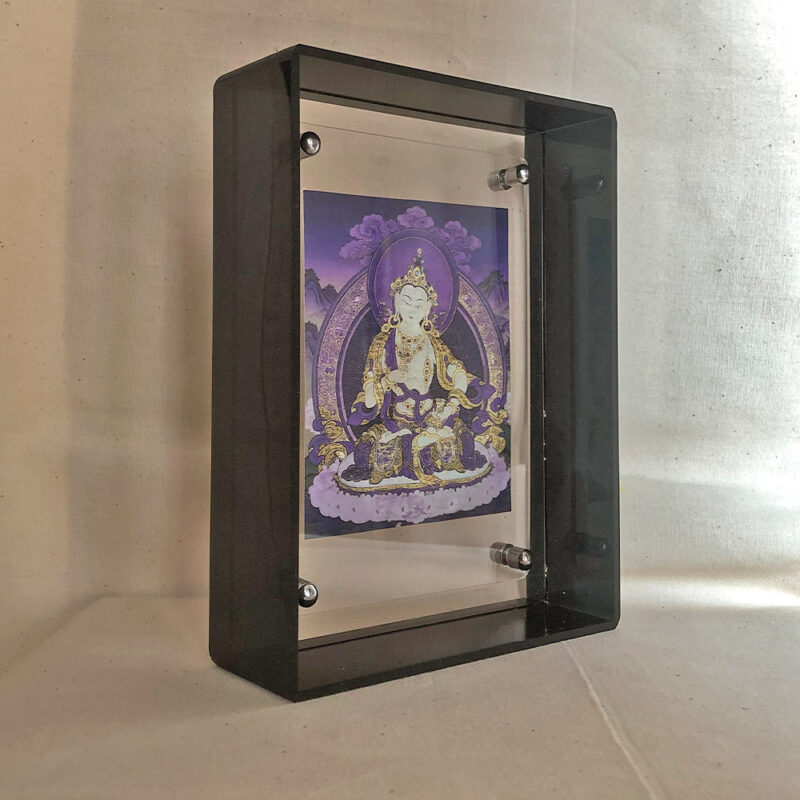 Side perspective of purple Vajrasattva Thangka print inside a black acrylic display frame.
