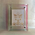 Front view of white Jambhala Buddha Eyes print in an iridescent floating translucent acrylic frame.