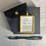 White Tara Buddha Eyes Gau box necklace presented with cord, pouch, and gift box.