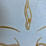 Close-up of original hand-painted gold linework and wisdom Buddha eyes on white canvas texture.