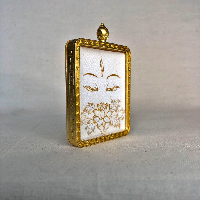 Three-quarter side angle of White Tara Buddha Eyes gold brass Gau box pendant.