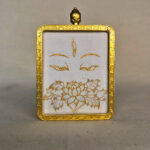 Frontal view of White Tara Buddha Eyes pendant for Crown Chakra color meditation.