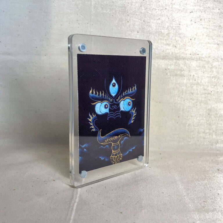 Side-angle view of freestanding clear acrylic block displaying Yamantaka line art.