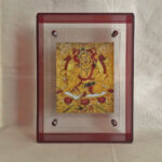 Front view of Yellow Jambhala Thangka print in a red floating translucent acrylic frame.
