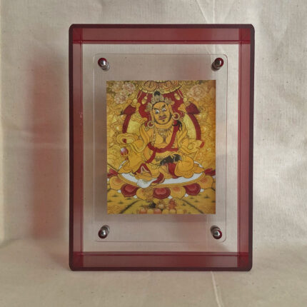 Front view of Yellow Jambhala Thangka print in a red floating translucent acrylic frame.