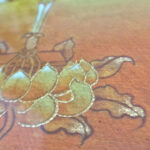Close-up of original hand-painted gold leaf details on yellow lotus element canvas.