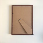 Flat back view of A4 picture frame showing backboard and flexible metal retaining clips