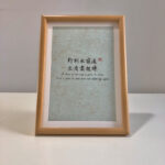 Frontal view of A4 framed Chinese calligraphy art print on clean desk