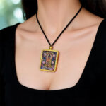Amitabha Buddha artwork in gold-toned Ghau pendant casing