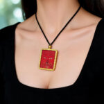 Gold Ghau pendant with hand-drawn Amitayus Buddha eye in orange gold