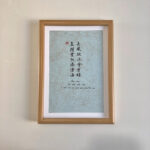 A4 framed Chinese calligraphy art print with natural wood frame hanging on wall for home decor