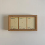 Rear view of 3 calligraphy panels with English handwritten labels for Guan, Yun, and An