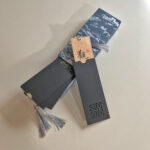 Handwritten Chinese calligraphy bookmark set with premium blue patterned gift box and protective sleeves.