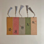 Set of 5 handwritten Chinese calligraphy bookmarks on colorful Xuan paper with silk tassels and red seal stamps.