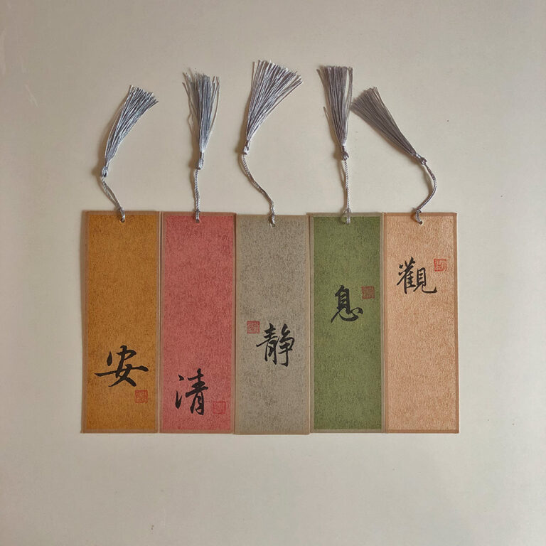 Set of 5 handwritten Chinese calligraphy bookmarks on colorful Xuan paper with silk tassels and red seal stamps.