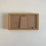 Flat rear view of horizontal natural wood table frame showing craft backing and foldable easel stand