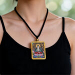 Gold Ghau pendant showcasing Mahasthamaprapta Thangka-inspired art