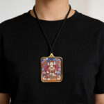 Mahavairocana Thangka-inspired art in rectangular gold Ghau pendant