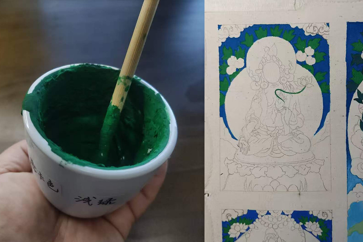 Hand holding a ceramic bowl of rich malachite green mineral pigment with a brush painting fine lines on canvas.