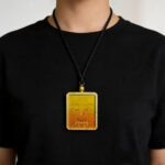 Yellow Ghau pendant featuring hand-drawn Manjushri Buddha eye art