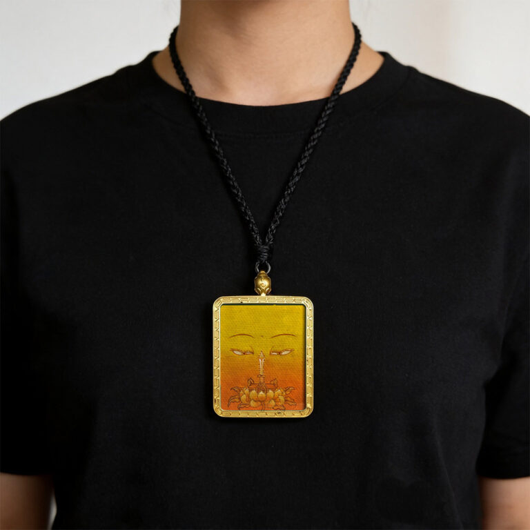Yellow Ghau pendant featuring hand-drawn Manjushri Buddha eye art