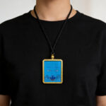 Contemporary blue Ghau pendant with hand-drawn Medicine Buddha eye art