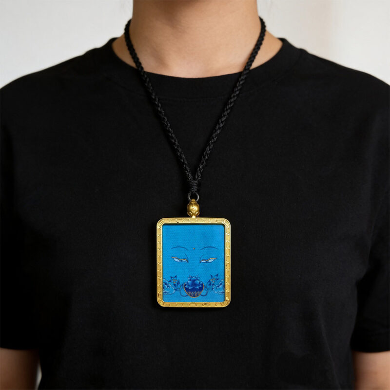 Contemporary blue Ghau pendant with hand-drawn Medicine Buddha eye art