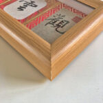Macro detail of smooth natural wood frame corner showcasing Guan Yun An 3-panel calligraphy