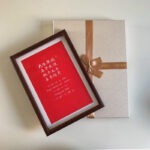 Framed red love poetry print in dark wood frame with luxury gift box packaging